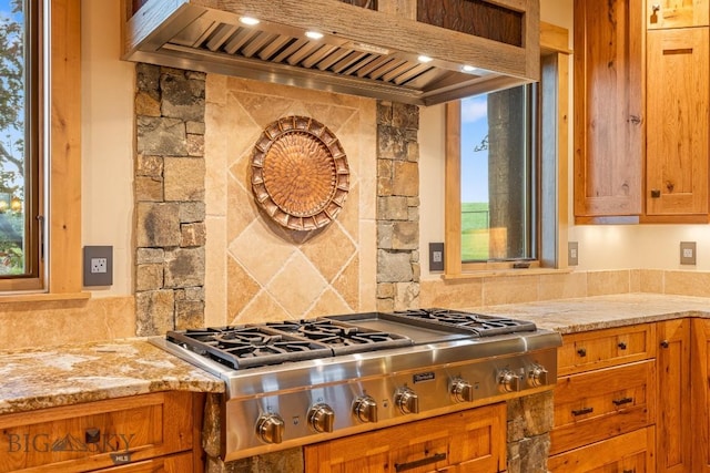 715 Bates Rd, Manhattan, MT 59741 - kitchen featuring stainless steel gas stovetop, premium range hood, and brown cabinets