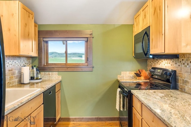 715 Bates Rd, Manhattan, MT 59741 - kitchen featuring black appliances, light brown cabinets, and decorative backsplash