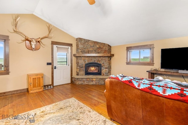 715 Bates Rd, Manhattan, MT 59741 - living area featuring vaulted ceiling, wood finished floors, healthy amount of natural light, a fireplace, and baseboards