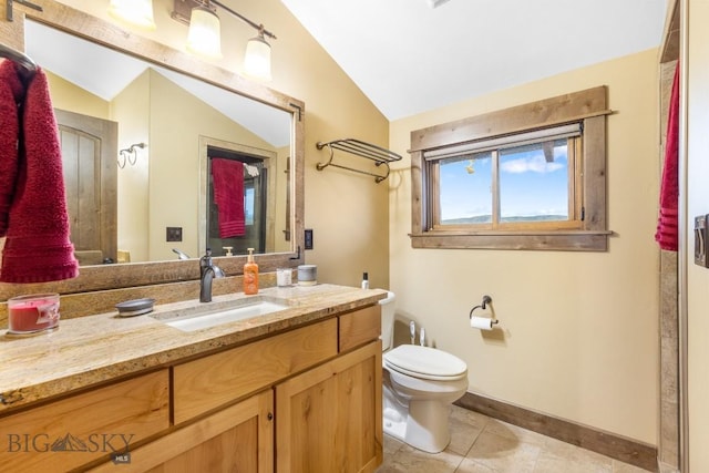 715 Bates Rd, Manhattan, MT 59741 - full bath featuring vaulted ceiling, vanity, toilet, baseboards, and tile patterned flooring