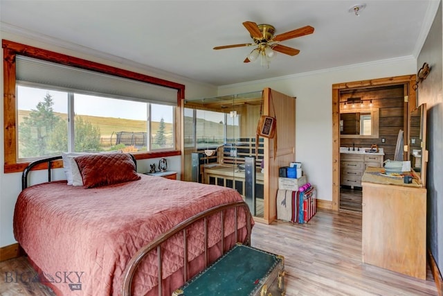 996 Forest Grove Rd, Lewistown, MT 59457 - bedroom featuring wood finished floors, crown molding, baseboards, and a sink