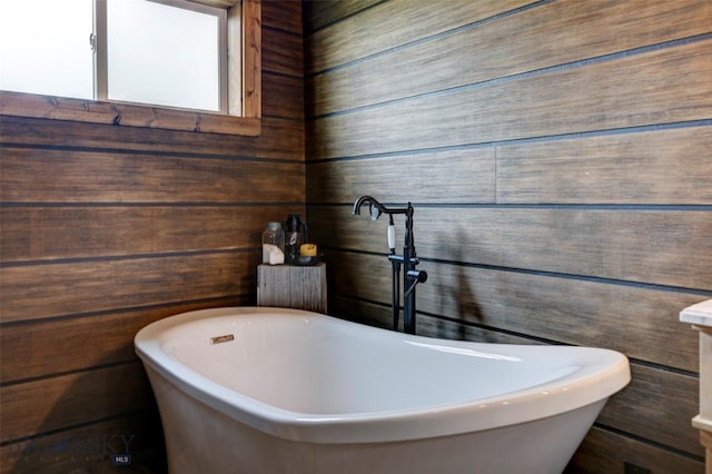 996 Forest Grove Rd, Lewistown, MT 59457 - full bathroom with a freestanding tub and wood walls