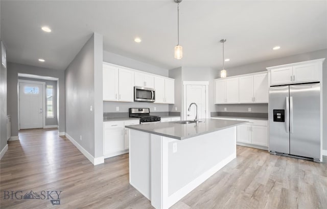 1518 Deadwood Loop, Belgrade, MT 59714 - kitchen with stainless steel appliances, a sink, recessed lighting, baseboards, and light wood-style flooring