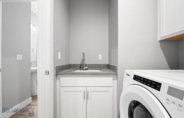 1518 Deadwood Loop, Belgrade, MT 59714 - laundry room featuring cabinet space, light wood-style flooring, and baseboards