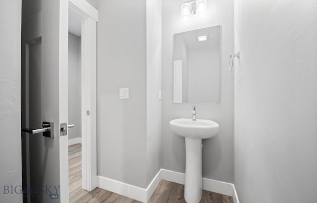 1518 Deadwood Loop, Belgrade, MT 59714 - bathroom with baseboards, wood finished floors, and a sink