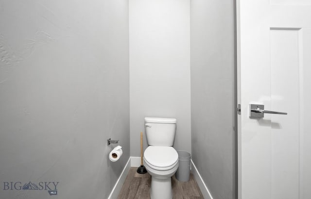1518 Deadwood Loop, Belgrade, MT 59714 - bathroom featuring wood finished floors, toilet, and baseboards
