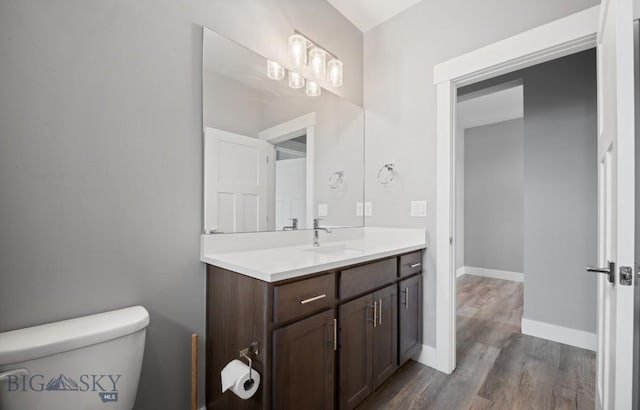 1518 Deadwood Loop, Belgrade, MT 59714 - bathroom featuring vanity, wood finished floors, toilet, and baseboards
