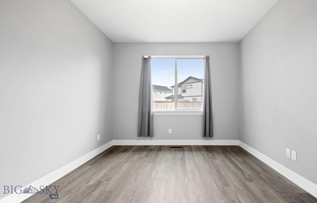 1518 Deadwood Loop, Belgrade, MT 59714 - unfurnished room with wood finished floors and baseboards