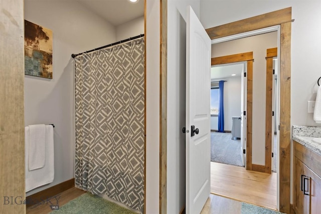 3483 Highline Rd, Manhattan, MT 59741 - bathroom with vanity, wood finished floors, curtained shower, and baseboards