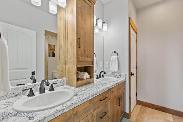 3483 Highline Rd, Manhattan, MT 59741 - full bath featuring double vanity, toilet, and baseboards