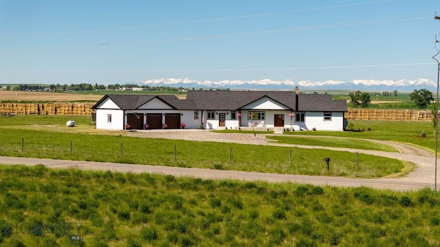 3483 Highline Rd, Manhattan, MT 59741 - view of front of house with dirt driveway, a garage, a mountain view, and a view of countryside