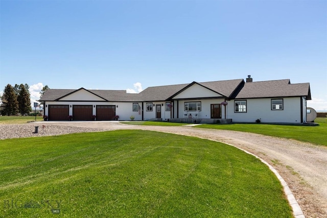 3483 Highline Rd, Manhattan, MT 59741 - ranch-style house with curved driveway, a garage, and a front yard