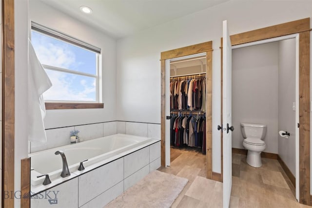 3483 Highline Rd, Manhattan, MT 59741 - bathroom featuring toilet, a bath, and a walk in closet