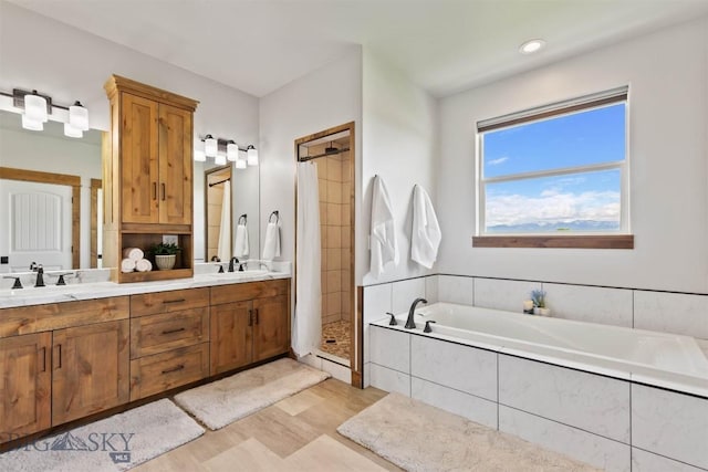 3483 Highline Rd, Manhattan, MT 59741 - bathroom with a bath, double vanity, a shower stall, and wood finished floors