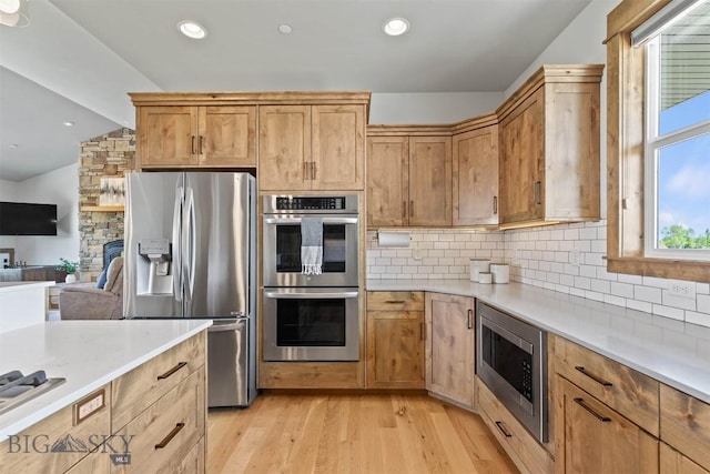 3483 Highline Rd, Manhattan, MT 59741 - kitchen featuring stainless steel appliances, light countertops, light wood finished floors, tasteful backsplash, and lofted ceiling