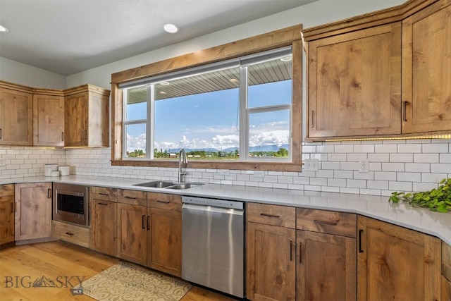 3483 Highline Rd, Manhattan, MT 59741 - kitchen with stainless steel appliances, a sink, light wood finished floors, brown cabinets, and recessed lighting