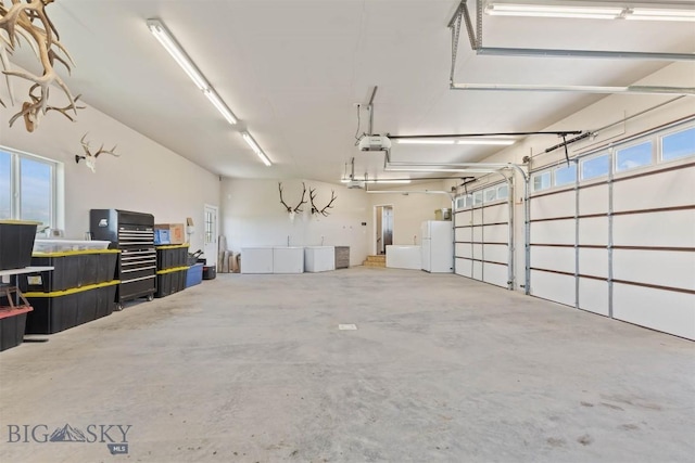 3483 Highline Rd, Manhattan, MT 59741 - garage featuring a garage door opener and freestanding refrigerator