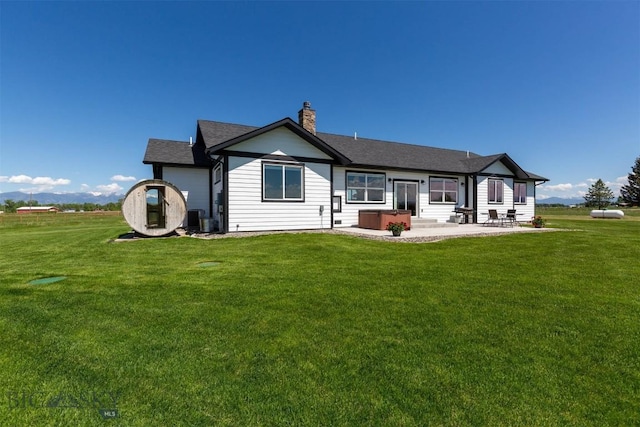 3483 Highline Rd, Manhattan, MT 59741 - rear view of house featuring a patio, a yard, a chimney, and cooling unit