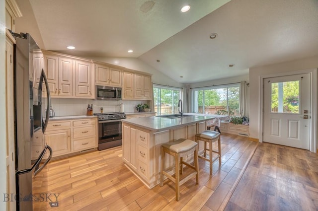 118 Clinton, Belgrade, MT 59714 - kitchen with appliances with stainless steel finishes, light countertops, a kitchen bar, light wood-style flooring, and lofted ceiling