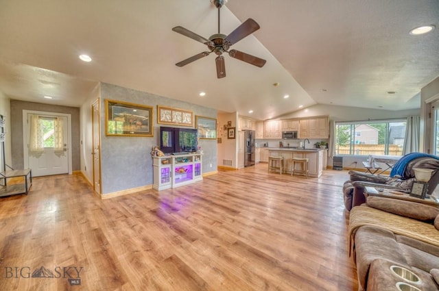 118 Clinton, Belgrade, MT 59714 - living area with vaulted ceiling, healthy amount of natural light, a ceiling fan, recessed lighting, and light wood finished floors