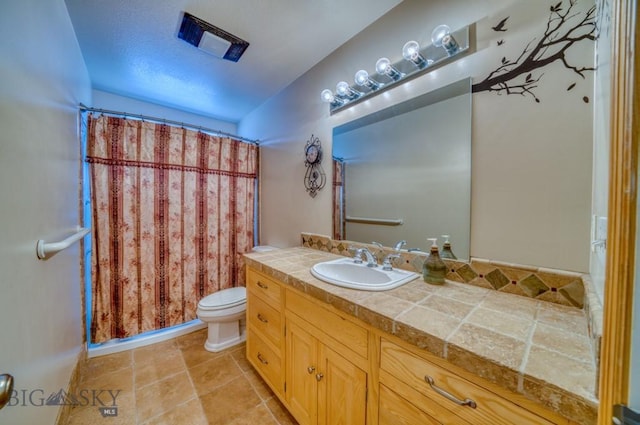 118 Clinton, Belgrade, MT 59714 - full bath featuring vanity, curtained shower, and tile patterned flooring