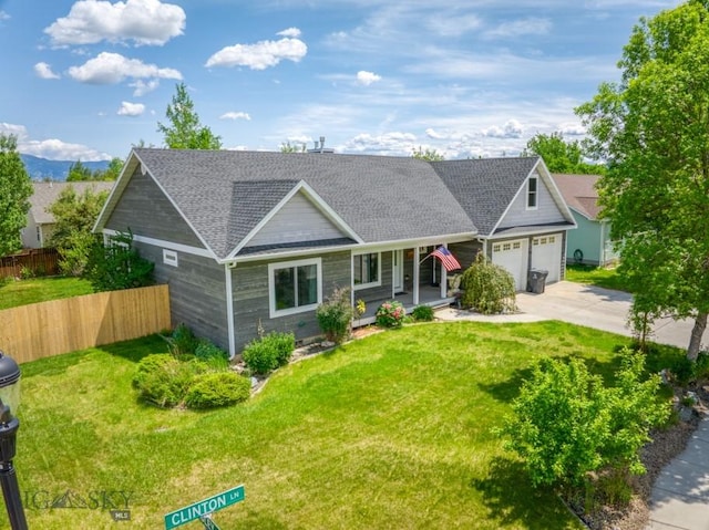 118 Clinton, Belgrade, MT 59714 - view of front of property with driveway, an attached garage, a shingled roof, and a porch