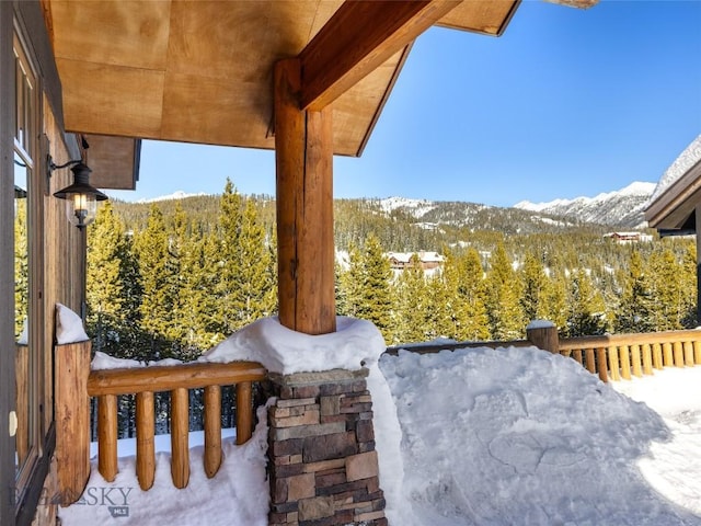18 Upper Cascade Ridge Rd Unit 18, Big Sky, MT 59716 - snow covered patio featuring a mountain view and a view of trees
