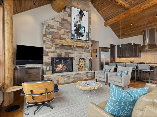 18 Upper Cascade Ridge Rd Unit 18, Big Sky, MT 59716 - living area featuring wood ceiling with exposed beams, wood finished floors, a stone fireplace, and high vaulted ceiling