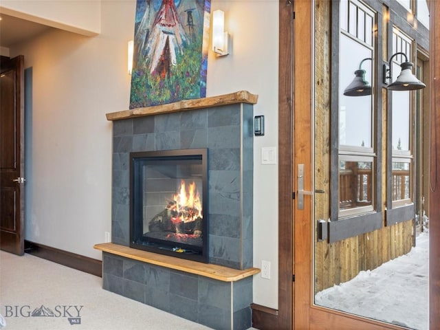 18 Upper Cascade Ridge Rd Unit 18, Big Sky, MT 59716 - detailed view of a tile fireplace, carpet, and baseboards