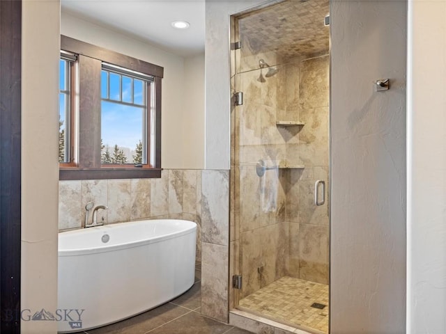 18 Upper Cascade Ridge Rd Unit 18, Big Sky, MT 59716 - full bath with a soaking tub, a stall shower, tile patterned flooring, tile walls, and recessed lighting