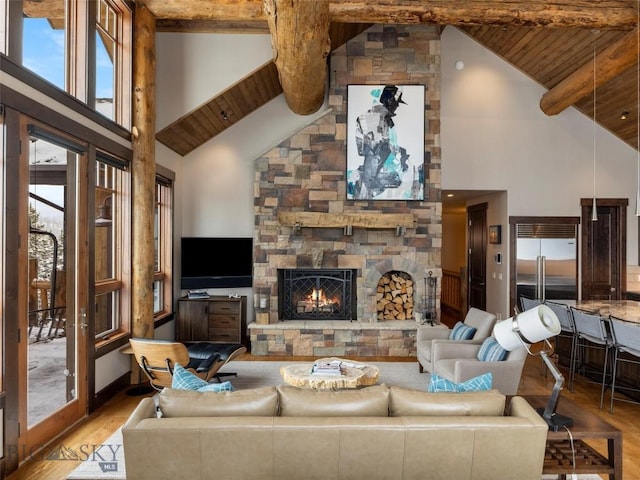 18 Upper Cascade Ridge Rd Unit 18, Big Sky, MT 59716 - living room with high vaulted ceiling, wood finished floors, wooden ceiling with exposed beams, and a stone fireplace