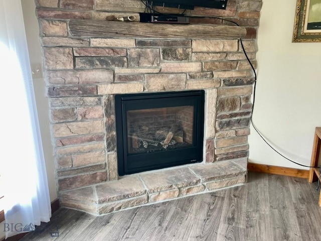 121 Ridge Ct, Dillon, MT 59725 - detailed view of wood finished floors, baseboards, and a fireplace with raised hearth