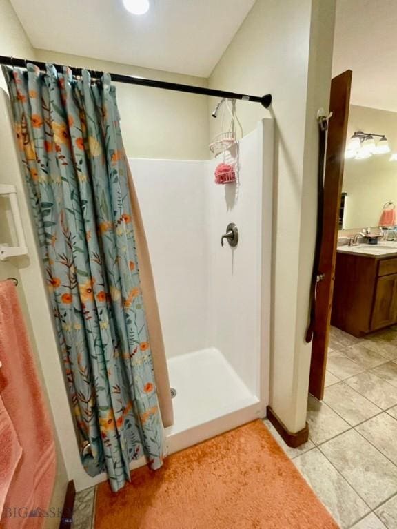 121 Ridge Ct, Dillon, MT 59725 - full bath featuring a shower with curtain, vanity, and tile patterned floors