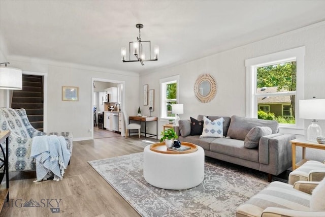 643 Parkhill, Billings, MT 59102 - living area featuring a chandelier, wood finished floors, and baseboards