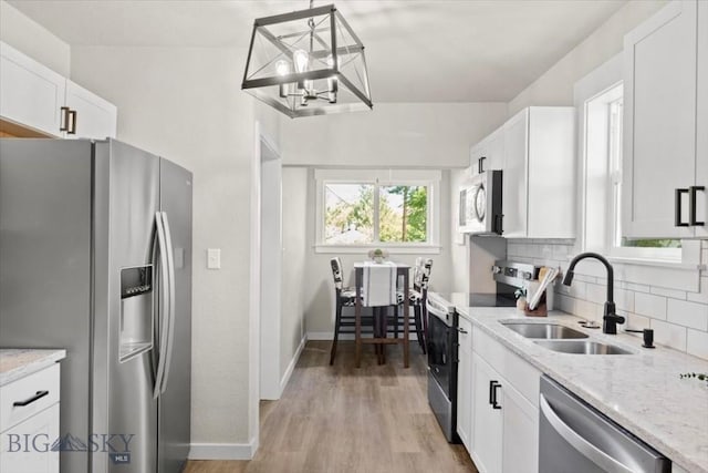 643 Parkhill, Billings, MT 59102 - kitchen featuring stainless steel appliances, a sink, decorative backsplash, white cabinetry, and light stone counters