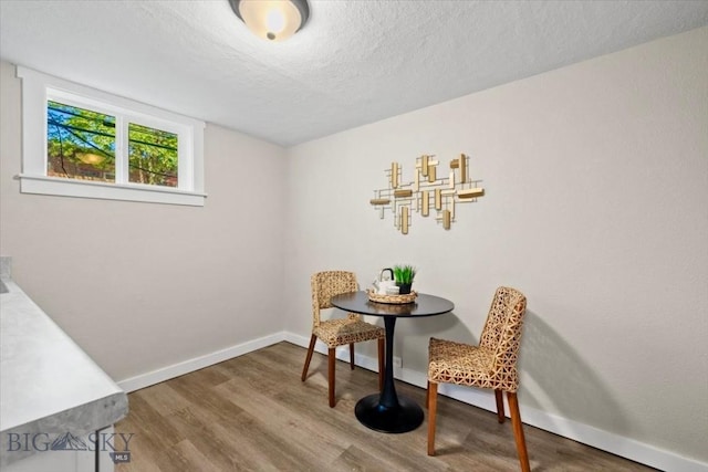 643 Parkhill, Billings, MT 59102 - dining area with wood finished floors, a textured ceiling, and baseboards