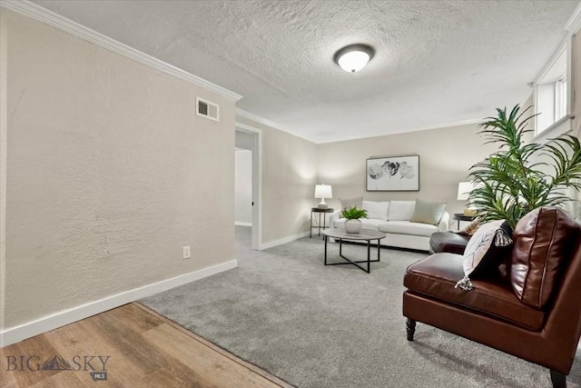 643 Parkhill, Billings, MT 59102 - living area with a textured ceiling, baseboards, crown molding, a textured wall, and wood finished floors