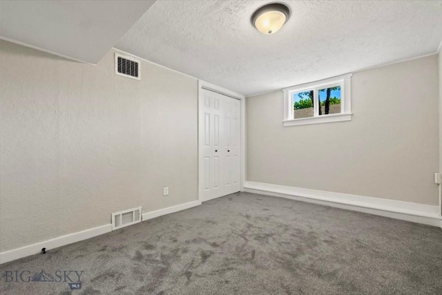 643 Parkhill, Billings, MT 59102 - basement featuring a textured ceiling, carpet flooring, and baseboards