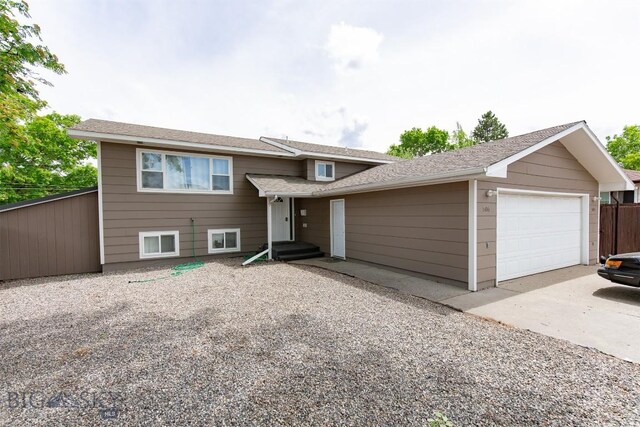 504 N 19th Ave, Bozeman, MT 59718 - tri-level home with an attached garage, driveway, and a shingled roof