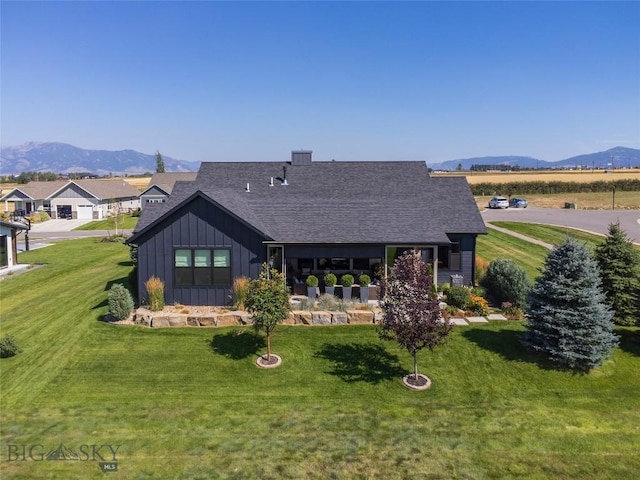 646 Arrow Trl, Bozeman, MT 59718 - rear view of property featuring board and batten siding, a mountain view, and a shingled roof