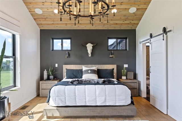 646 Arrow Trl, Bozeman, MT 59718 - bedroom with lofted ceiling, a barn door, wooden ceiling, wood finished floors, and a chandelier
