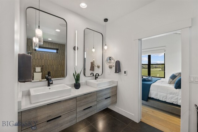 646 Arrow Trl, Bozeman, MT 59718 - ensuite bathroom featuring double vanity, recessed lighting, baseboards, and tile patterned floors