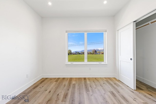 1704 W Lincoln Unit 5B, Bozeman, MT 59715 - unfurnished bedroom featuring baseboards, light wood-style flooring, recessed lighting, and a closet