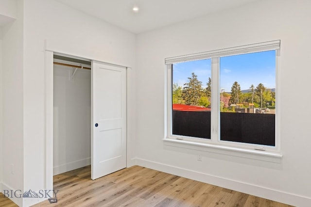 1704 W Lincoln Unit 5B, Bozeman, MT 59715 - unfurnished bedroom featuring light wood finished floors, recessed lighting, a closet, and baseboards