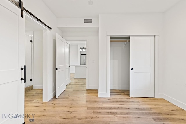 1704 W Lincoln Unit 5B, Bozeman, MT 59715 - unfurnished bedroom with light wood-type flooring and a closet