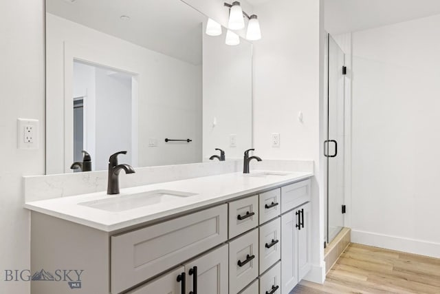 1704 W Lincoln Unit 5B, Bozeman, MT 59715 - full bathroom with wood finished floors, double vanity, a shower stall, and baseboards