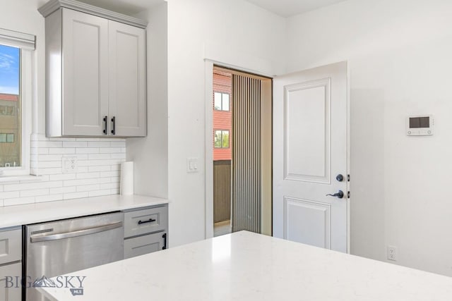 1704 W Lincoln Unit 5B, Bozeman, MT 59715 - kitchen with dishwasher, light countertops, decorative backsplash, and gray cabinetry