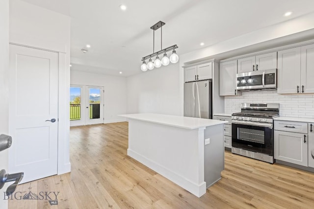 1704 W Lincoln Unit 5B, Bozeman, MT 59715 - kitchen with appliances with stainless steel finishes, gray cabinets, light countertops, backsplash, and recessed lighting