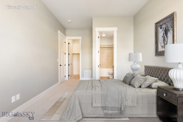 1609 Wyatt Earp Ct, Belgrade, MT 59714 - carpeted bedroom with baseboards and ensuite bathroom