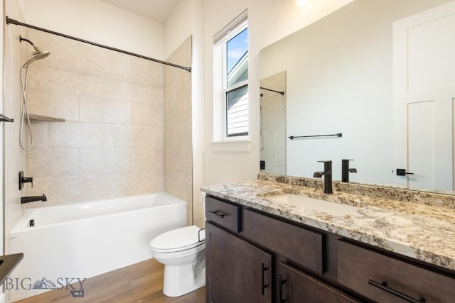 1609 Wyatt Earp Ct, Belgrade, MT 59714 - bathroom featuring toilet, vanity, wood finished floors, and tub / shower combination